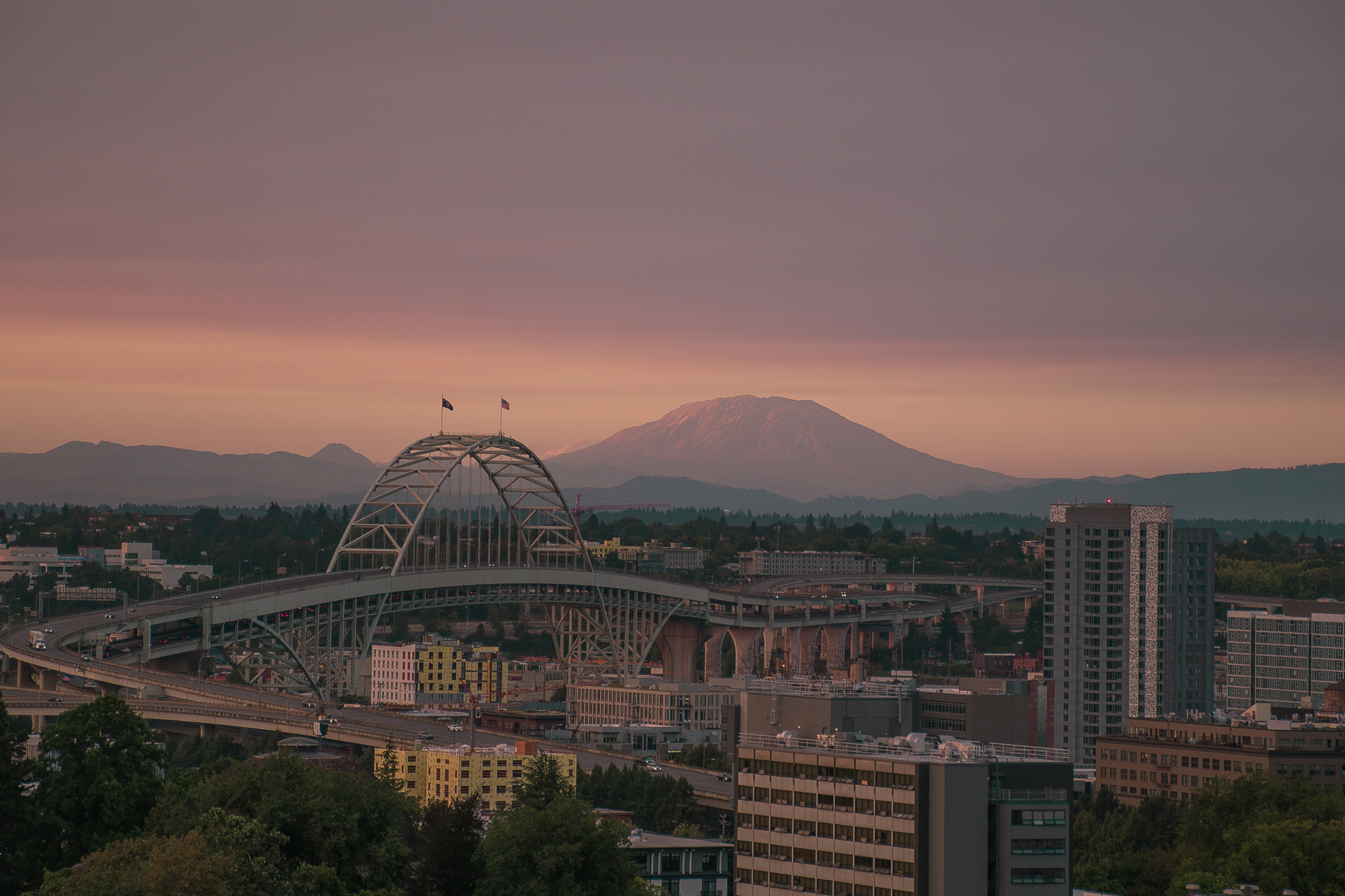 Portland skyline with the Fremont Bridge and a snow-capped mountain at dusk
